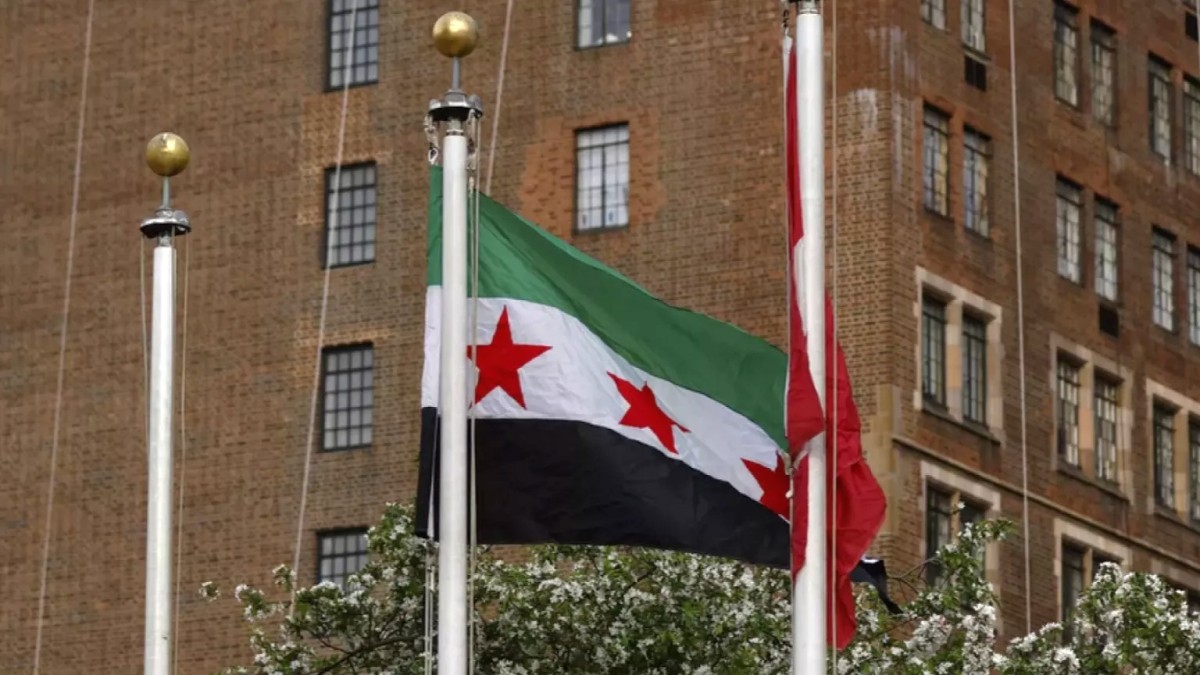 Prior to a meeting of the Security Council ... the new Syria flag is raised over the United Nations building in New York